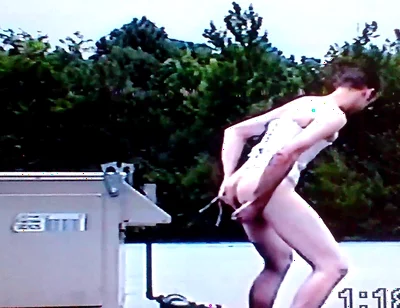 Crossdresser Riding a Giant Dildo on a Roof Top
