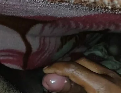Big Boss massaging penis oil under the blanket
