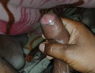 Big Boss massaging penis oil under the blanket