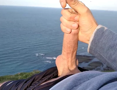 Huge Dirty Cock Gets Handjob on the Beach and Squirts a Lot of Thick Sperm in Front of the Beach