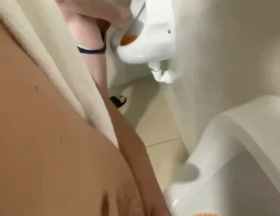 Filming the Guy Peeing Next to Me at the Urinal of the Pool Toilets