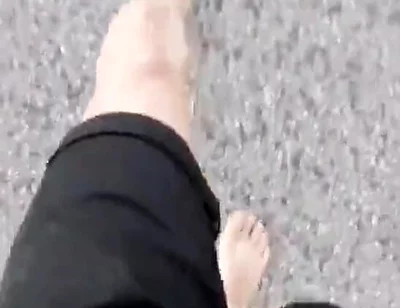 Jon Arteen Walks Barefoot on the Street Outdoors, the Boy Is Barefoot in the Crowded Tram to the Town Center