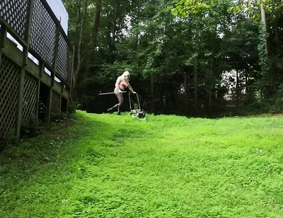 Big Fake Tits Crossdresser in Daisy Dukes Mowing Grass