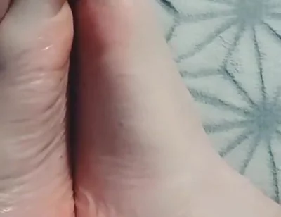Guy Gently Massages His Feet with Oil